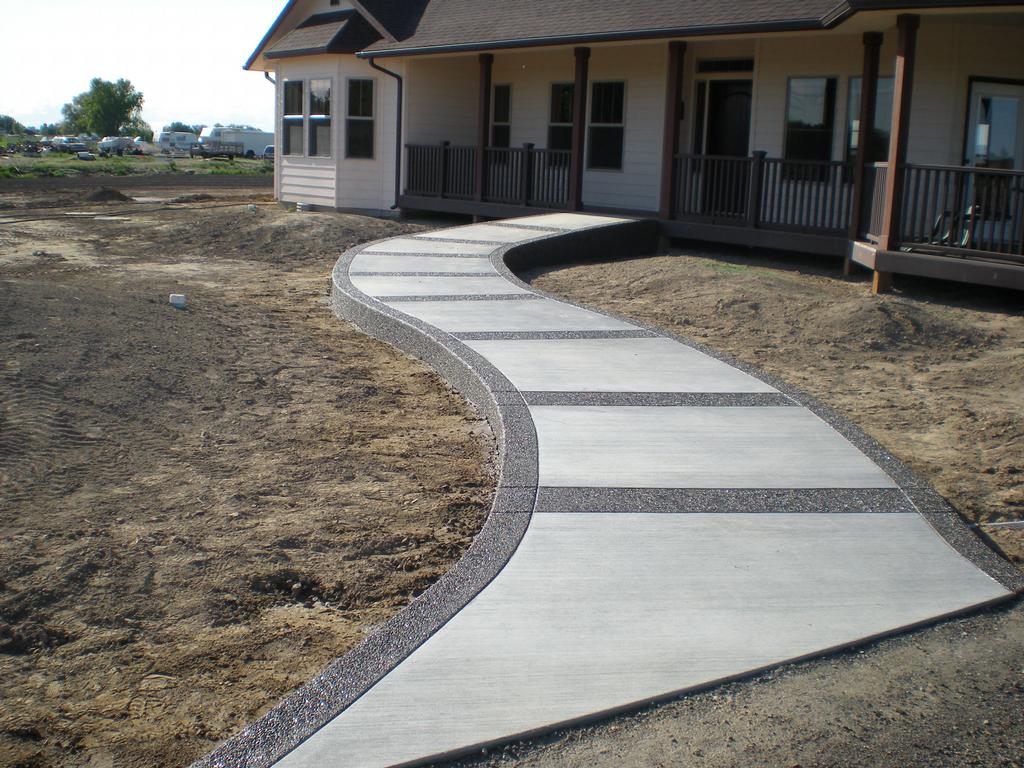 A completed sidewalk with stamped curved concrete